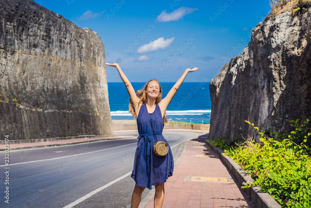 Φωτογραφία Young woman on Road to the beach Pandawa, Nusa Dua, Bali, Indonesia