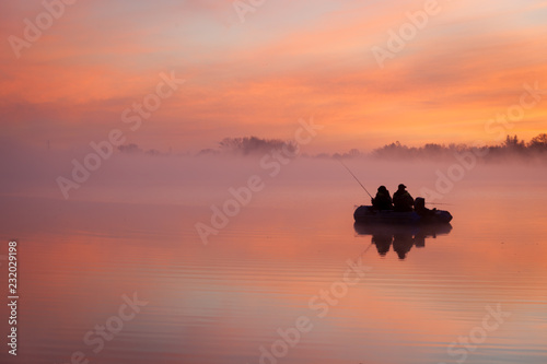 lake at sunrise in pink fog and clouds