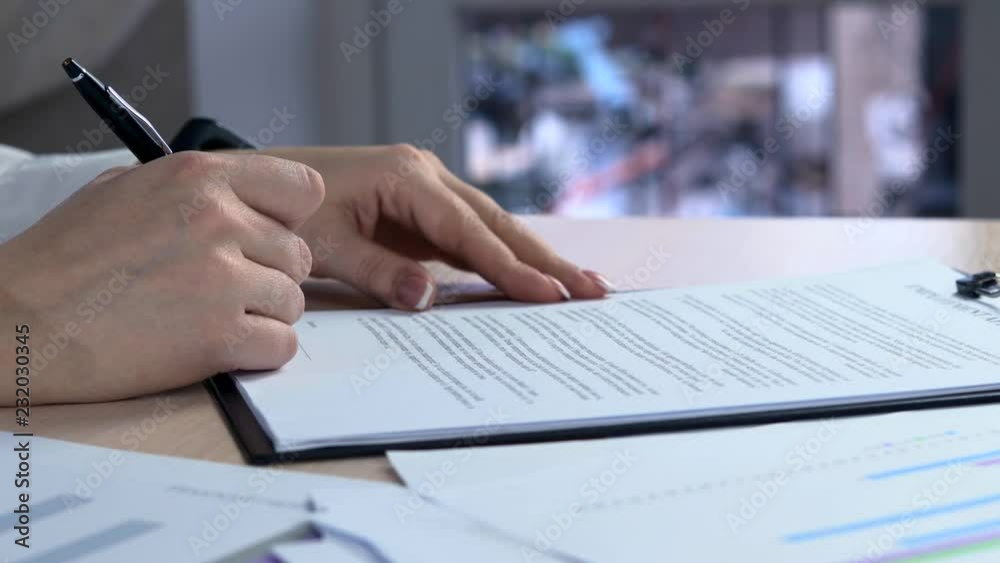 Business woman signs a agreement. Woman signs a document. Signing of the lease contract - fake signature Business woman signs a agreement. Woman signs a document. Signing of the lease contract - fake signature