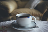 Coffee cup on table in moody atmosphere.