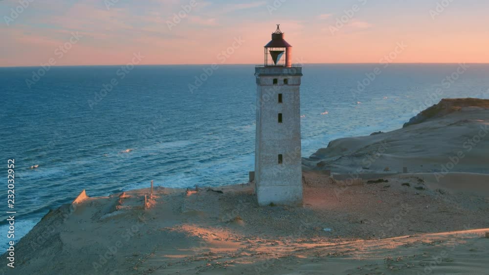Stunning rotating aerial full shot of the disused lighthouse Rubjerg Knude