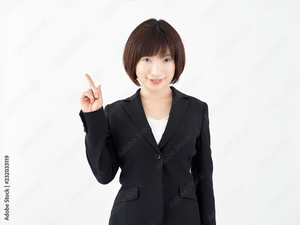 白い背景で1の指差しポーズをする女性OL 白い背景で1の指差しポーズをする女性OL