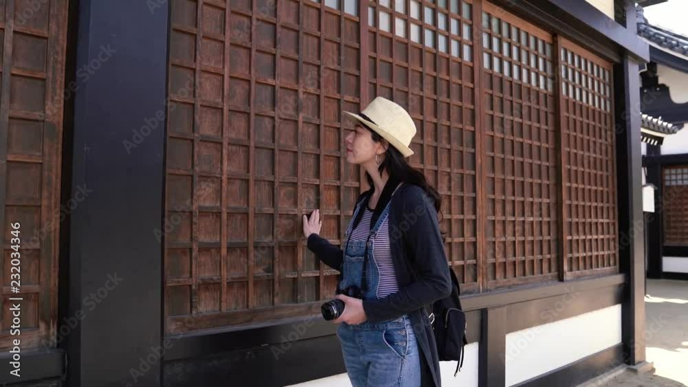 woman looking and touching the grid windows woman looking and touching the grid windows