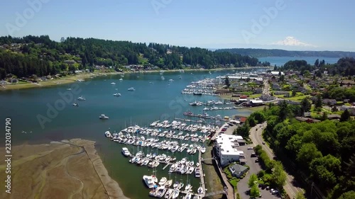 Gig Harbor During Low Tide Drone Flying Over a Marina Blue Water Cloudless Summer Day and Mt. Rainier. Drone Moving Forward. photo