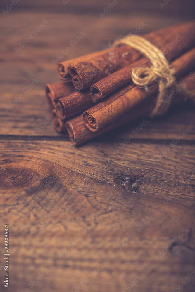 Spices for mulled wine: cinnamon sticks, star anise, slices of orange on a wooden background.