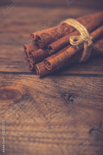 Spices for mulled wine: cinnamon sticks, star anise, slices of orange on a wooden background.