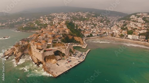 Beautiful drone shot flying along the coast of the city of Ulcinj, Montenegro photo