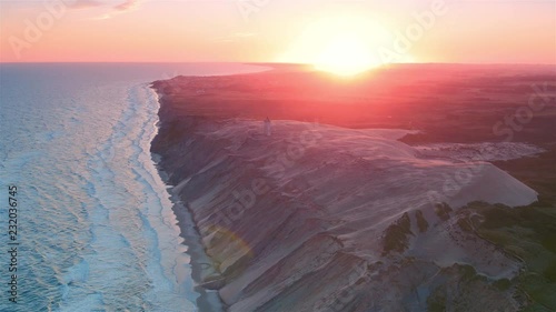 Stunning extreme wide shot of Rubjerg Knude lighthouse at dawn