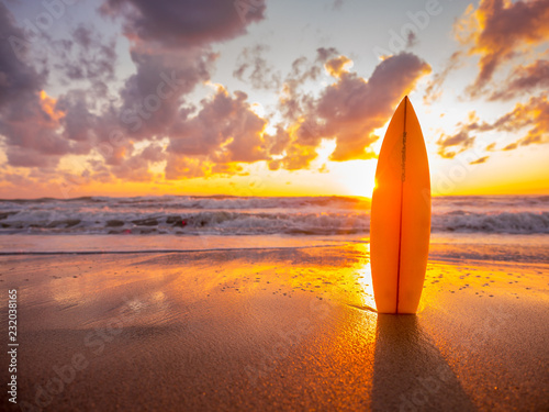 surfboard on the beach in sea shore at sunset time with beautiful light photo