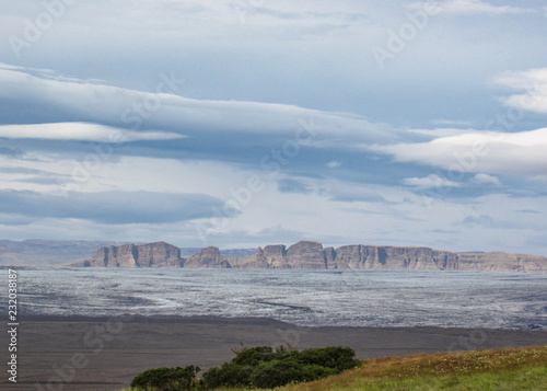 Panorama with mountain range, glacier tongue of Vatnajokull glacier and green vegetation, South Iceland photo