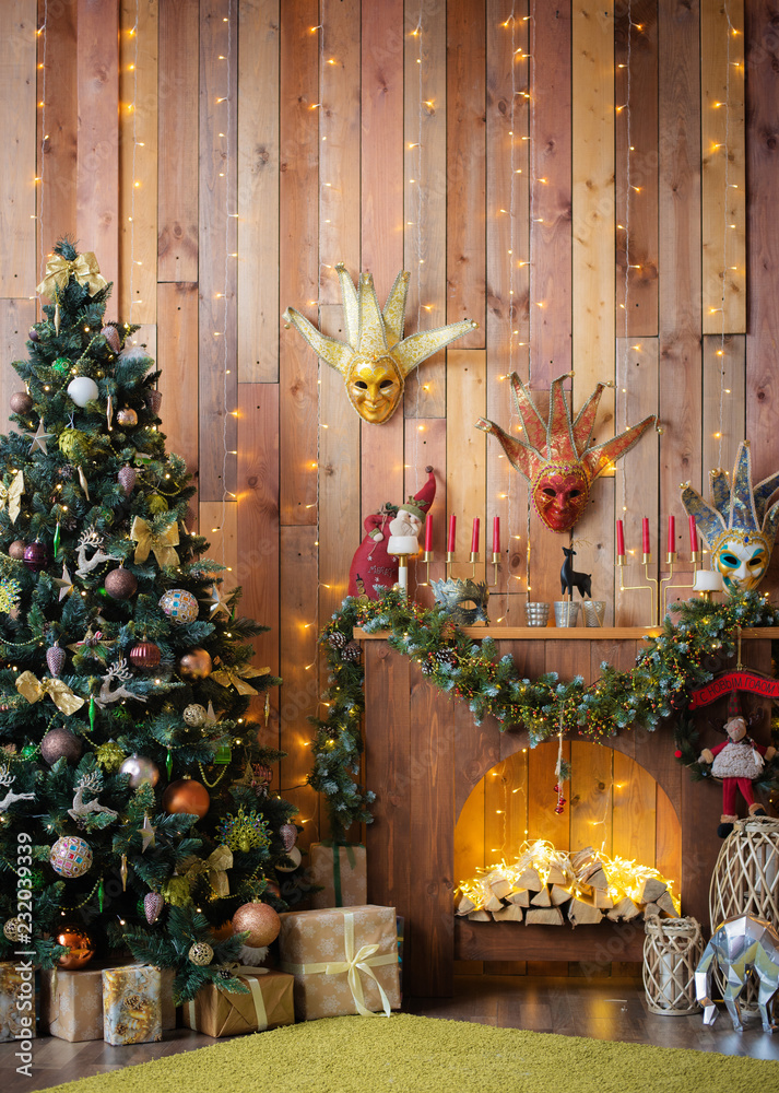 Christmas and New Year decorated the interior wooden room with gifts and a Christmas tree with a fireplace and carnival masks. Christmas and New Year decorated the interior wooden room with gifts and a Christmas tree with a fireplace and carnival masks.