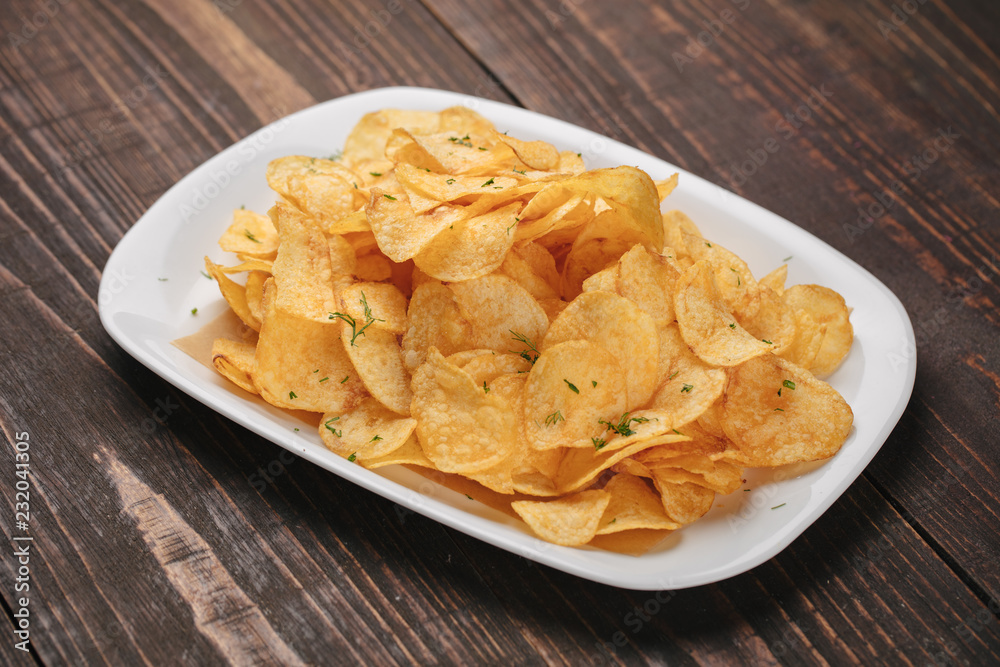 White plate with chips as beer snack White plate with chips as beer snack