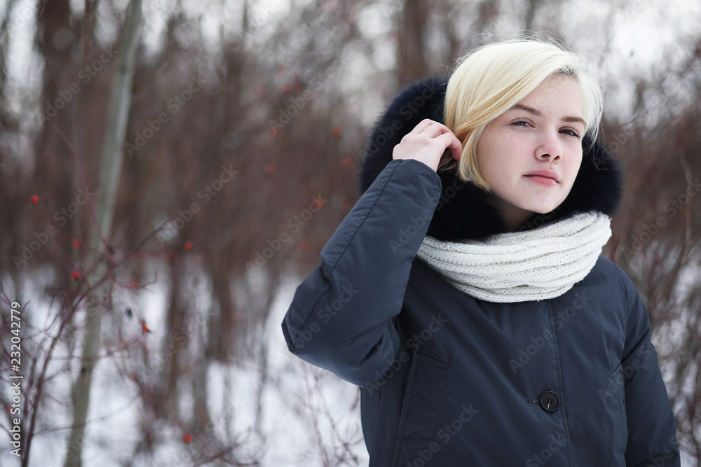 Young beautiful girl on a walk in winter park Young beautiful girl on a walk in winter park