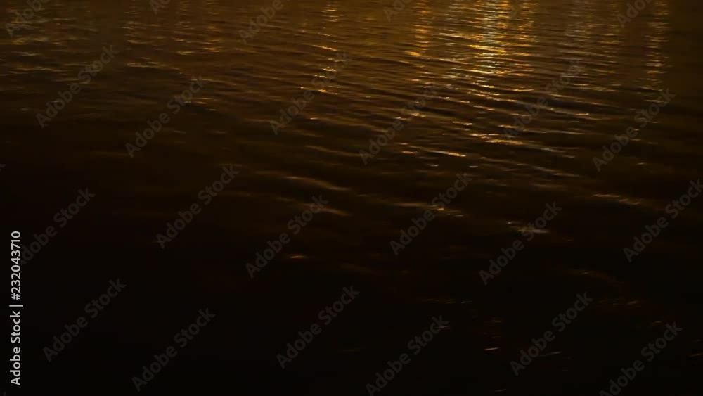 A reflection of nearby industrial port at night