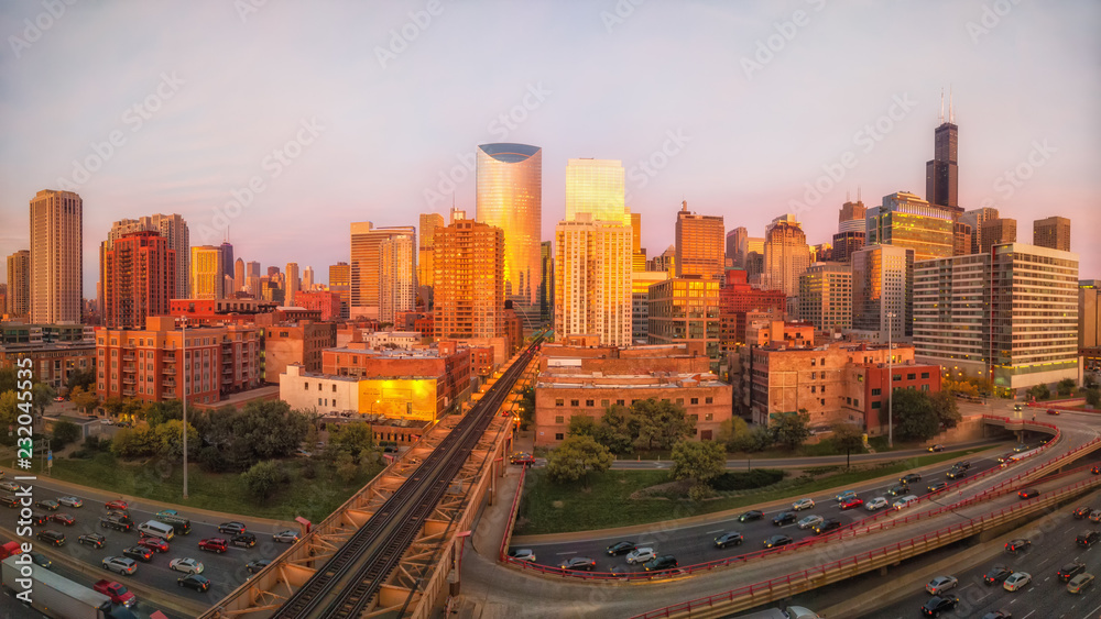 Panoramic perspective of Chicago's West Loop neighborhood during golden hour at Lake Street and Interstate 90. Illinois, USA.