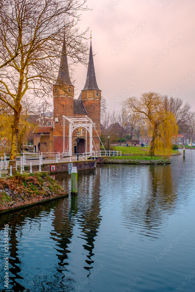 Evening view of the canal and the VVE Oostpoort de Delft. Dutch city in the spring after sunset. Holland, Netherlands.