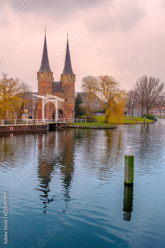 Evening view of the canal and the VVE Oostpoort de Delft. Dutch city in the spring after sunset. Holland, Netherlands.