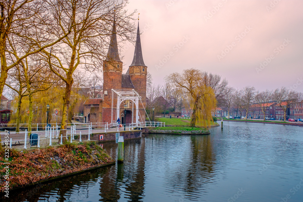 Evening view of the canal and the VVE Oostpoort de Delft. Dutch city in the spring after sunset. Holland, Netherlands.