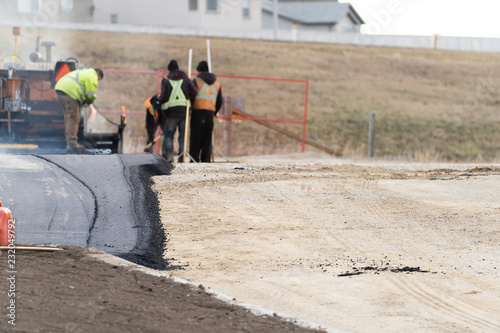 Costruction workers laying new Tarmac For New Parking Lot