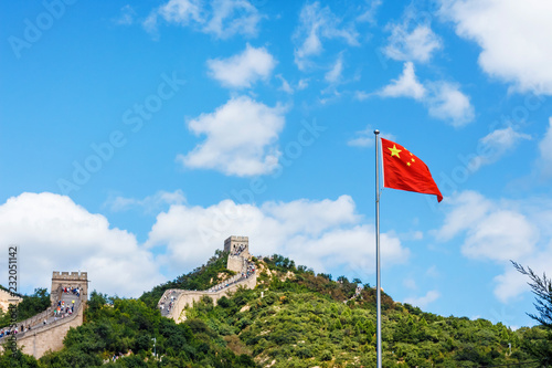The Great Wall of China. Chinese flag against the background of the blue sky and of the Great Wall