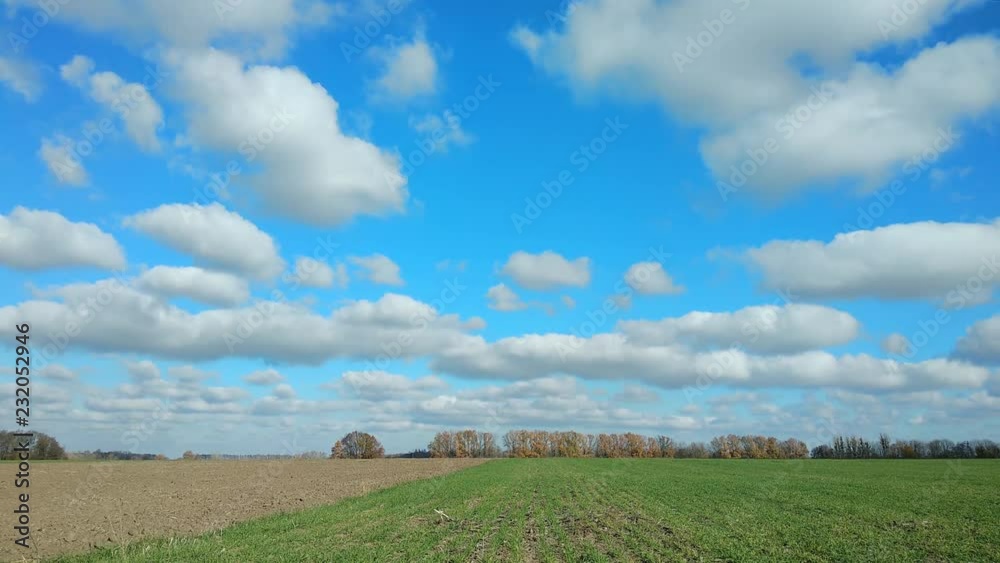 beautiful clouds move across the sky, the sun's rays go through the trees and the field. timelapse 4k beautiful clouds move across the sky, the sun's rays go through the trees and the field. timelapse 4k
