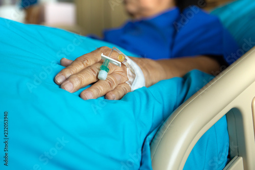 Blood test tube on senior woman patient hand in hospital.