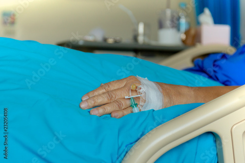 Blood test tube on senior woman patients hand in hospital.