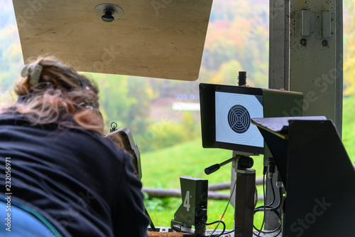 Woman with assault rifle on a shooting range in Switzerland