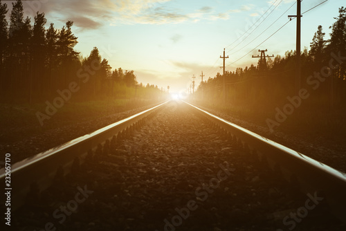 junction of railways track in trains station against beautiful light of sun set sky use for land transport and logistic industry background ,backdrop,copy space theme.