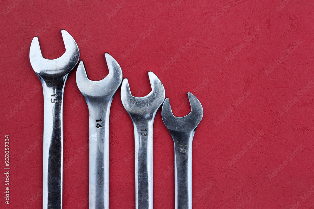 Chrome spanners on a red background. Chrome spanners on a red background.