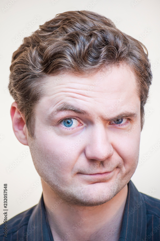 Man mistrustfully looking with raised eyebrow Man mistrustfully looking with raised eyebrow