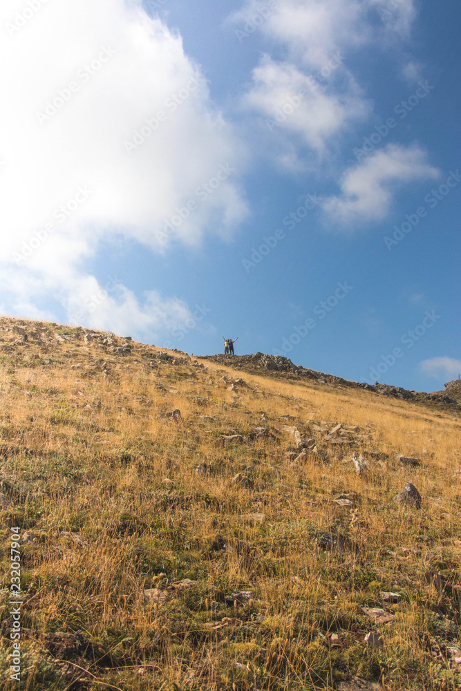 Anonymous couple standing on hill Anonymous couple standing on hill