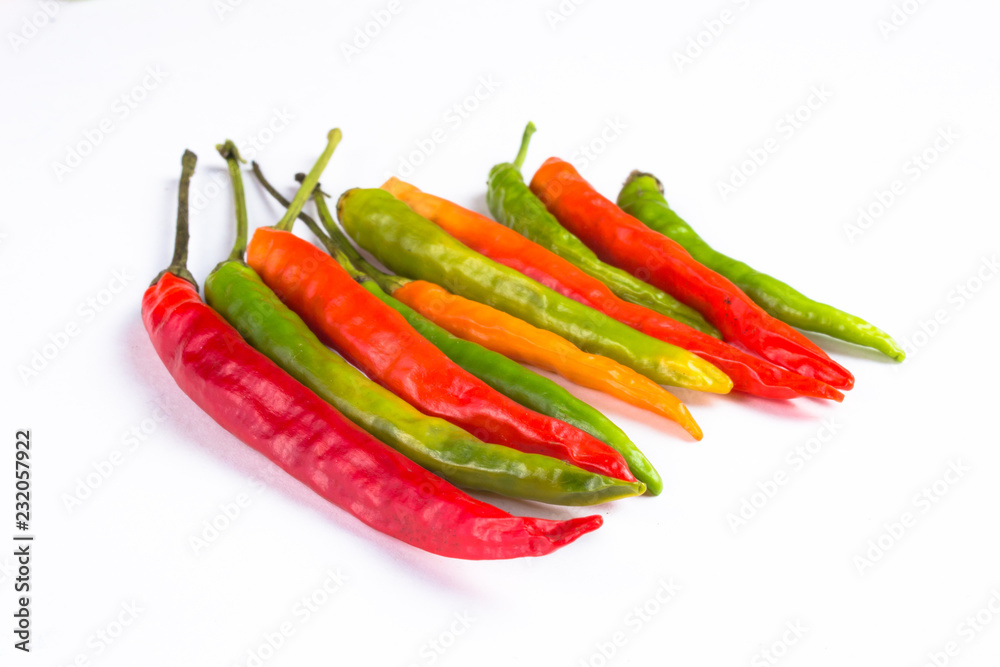 Close-up of colorful hot peppers. Group of red green and yellow peppers on white background
