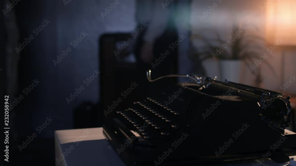 Man gets ready to write on an old dusty vintage typewriter
