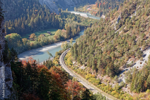Train in sunny autumnal Ruinaulta - Rheinschlucht (Rhine canyon), Illanz/Glion - Reichenau, Switzerland