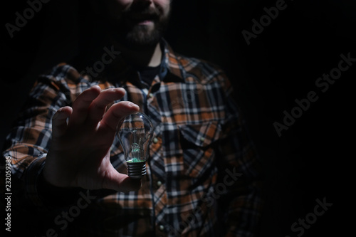 man hold glow lamp in hand