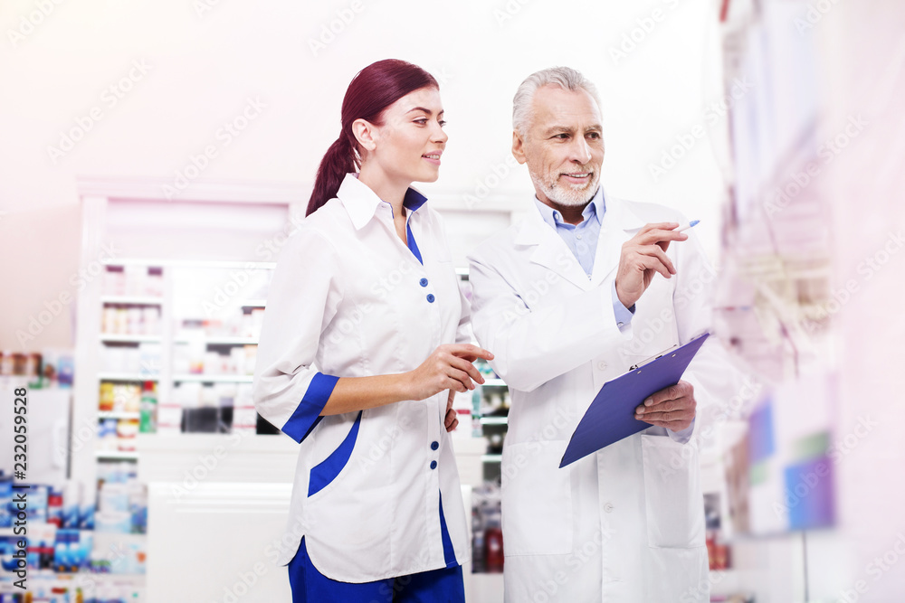 Fototapeta premium Pharmacists making a revision in a drugstore.
