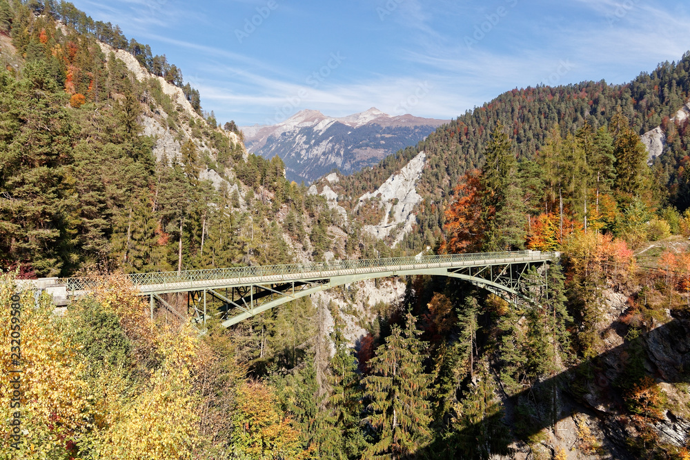 Old Versam bridge with sunny autumnal views of Ruinaulta - Rheinschlucht (Rhine canyon), Illanz/Glion - Reichenau, Switzerland Old Versam bridge with sunny autumnal views of Ruinaulta - Rheinschlucht (Rhine canyon), Illanz/Glion - Reichenau, Switzerland