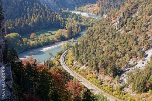 Train in sunny autumnal Ruinaulta - Rheinschlucht (Rhine canyon), Illanz/Glion - Reichenau, Switzerland photo