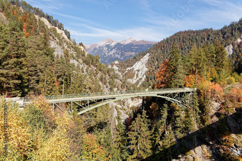 Old Versam bridge with sunny autumnal views of Ruinaulta - Rheinschlucht (Rhine canyon), Illanz/Glion - Reichenau, Switzerland