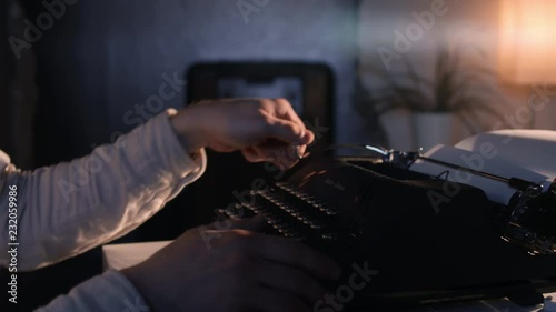 Man's hands type on an old vintage typewriter