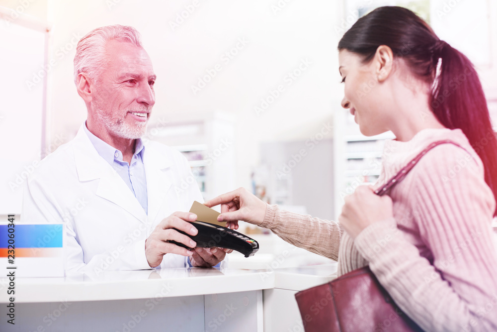 Customer swiping her credit card buying prescribed pills Customer swiping her credit card buying prescribed pills
