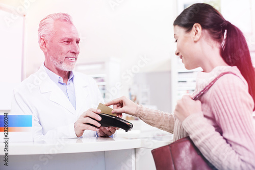 Customer swiping her credit card buying prescribed pills