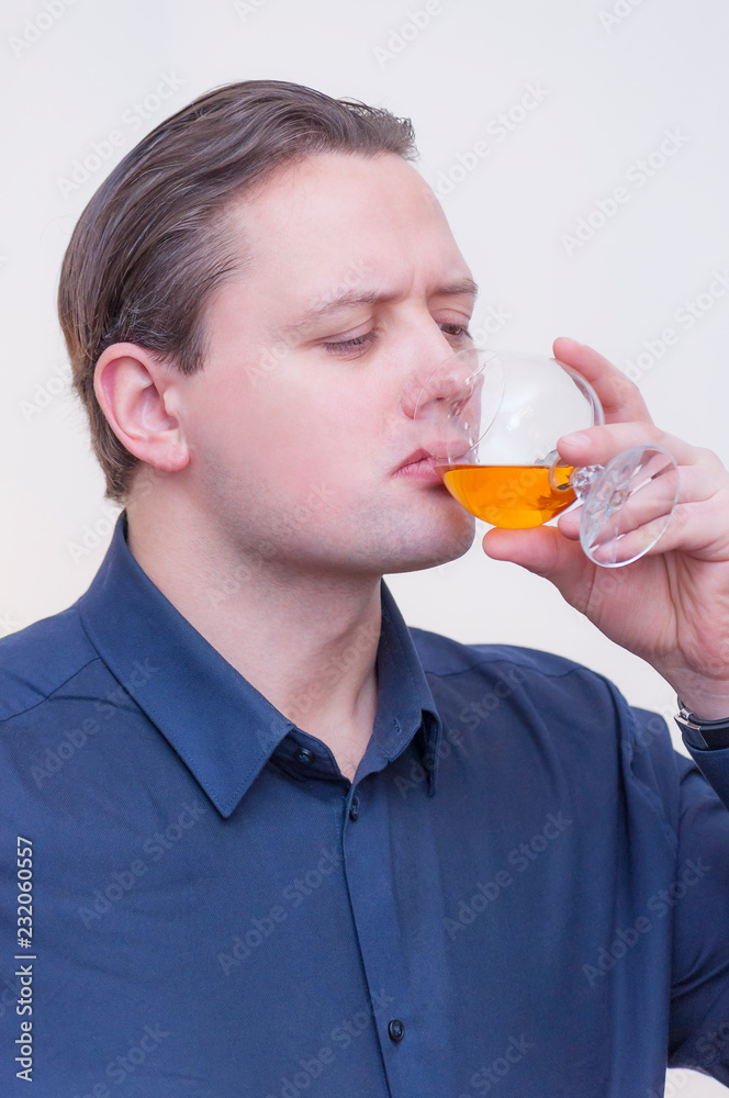 Fototapeta premium Man drinking whiskey or brandy alcohol drink