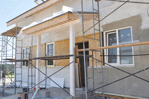 House renovation with plastering and painting walls. Renovate and insulate modern house with insulation and painting.