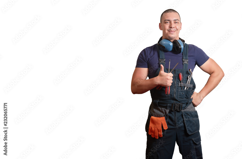 Strong male mechanic in blue overal standing on a white isolated background Strong male mechanic in blue overal standing on a white isolated background