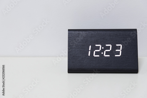 Black digital clock on a white background showing time 12:23 photo