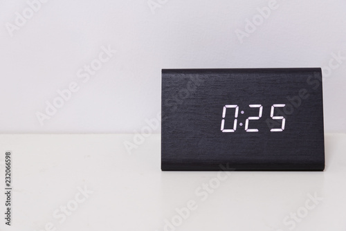 Black digital clock on a white background showing time 0:25 photo