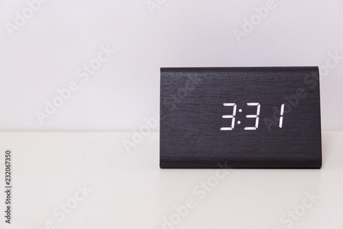 Black digital clock on a white background showing time 3:31 photo