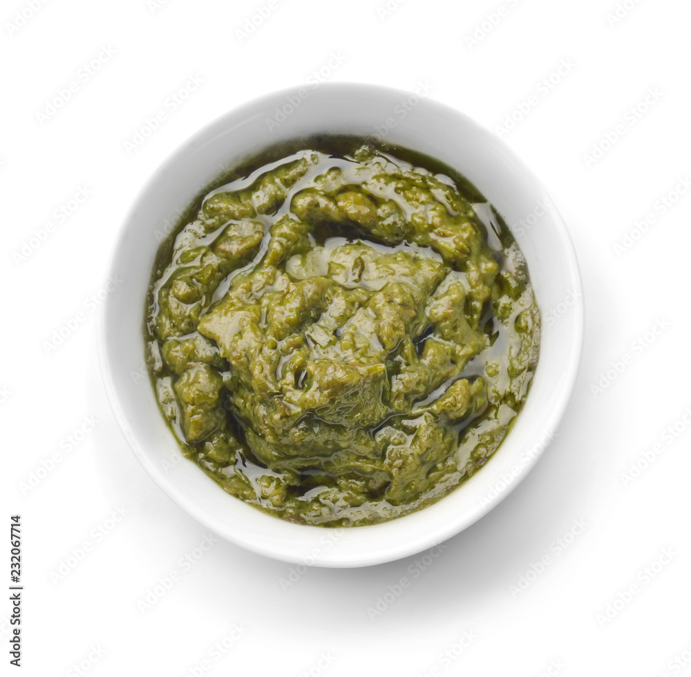 Tasty basil sauce in bowl on white background Tasty basil sauce in bowl on white background
